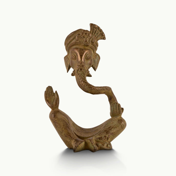 Stylized brass Ganesha statue with an elongated looping trunk and intricate turban.