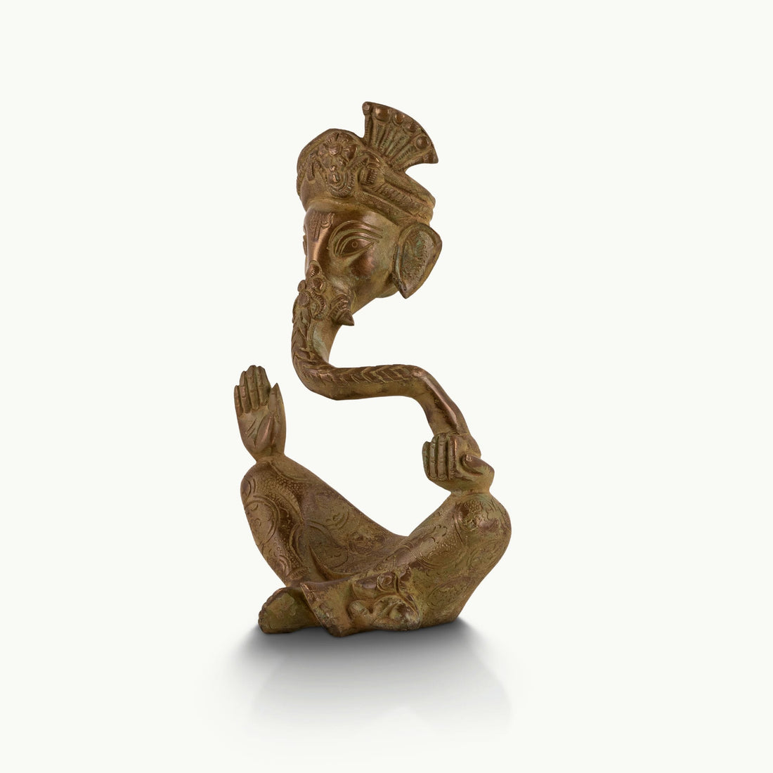 Antique abstract brass ganesha in meditative pose with turban