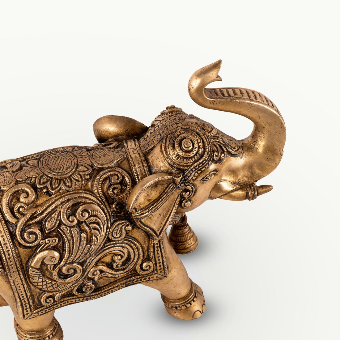 Engraved Golden Brass Elephant with a raised trunk for a dark walnut executive desk.