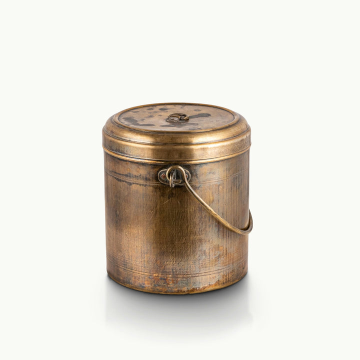 Antiqued brass storage bin featuring a heavy swing handle and deeply oxidized rustic finish.