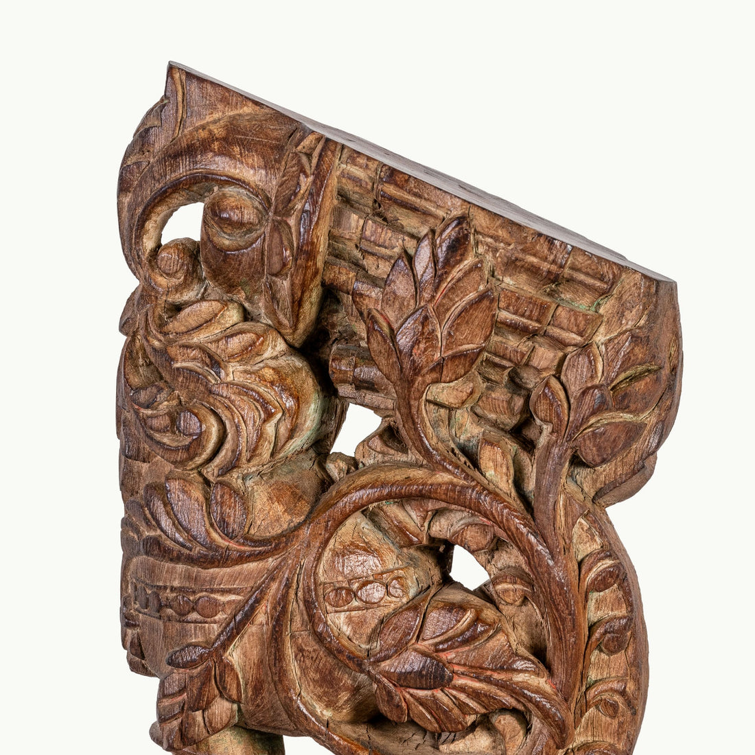 Carved wooden haveli bracket featuring a mythological avian sentinel.