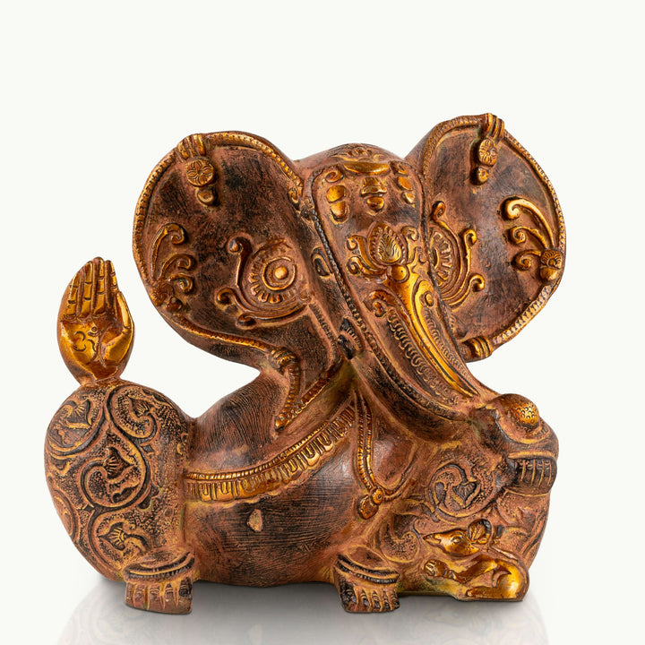 Engraved Brass Ganesha Statue seated in tranquility for an entryway console. 