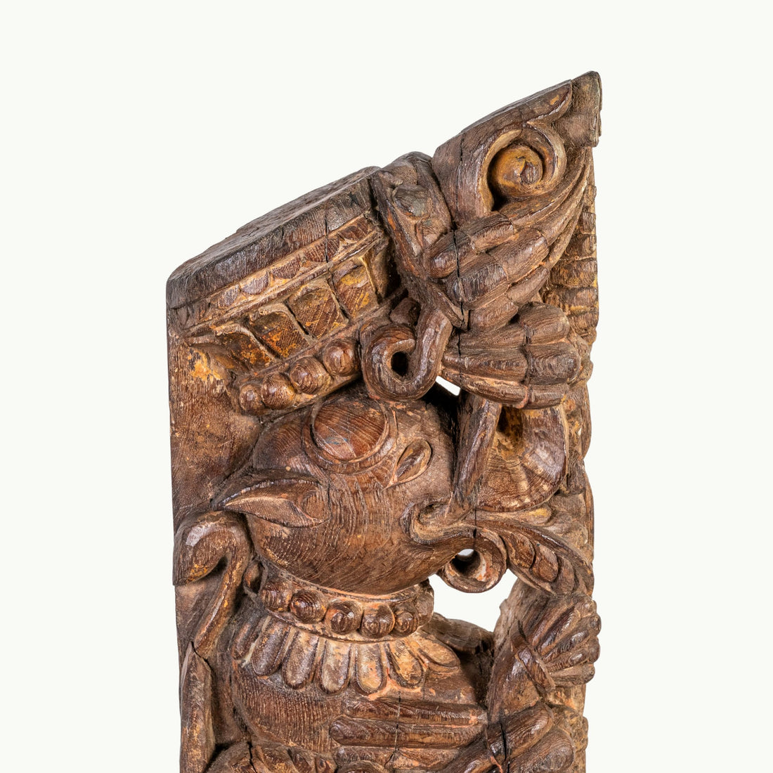 Carved wooden haveli bracket featuring a mythological avian sentinel.