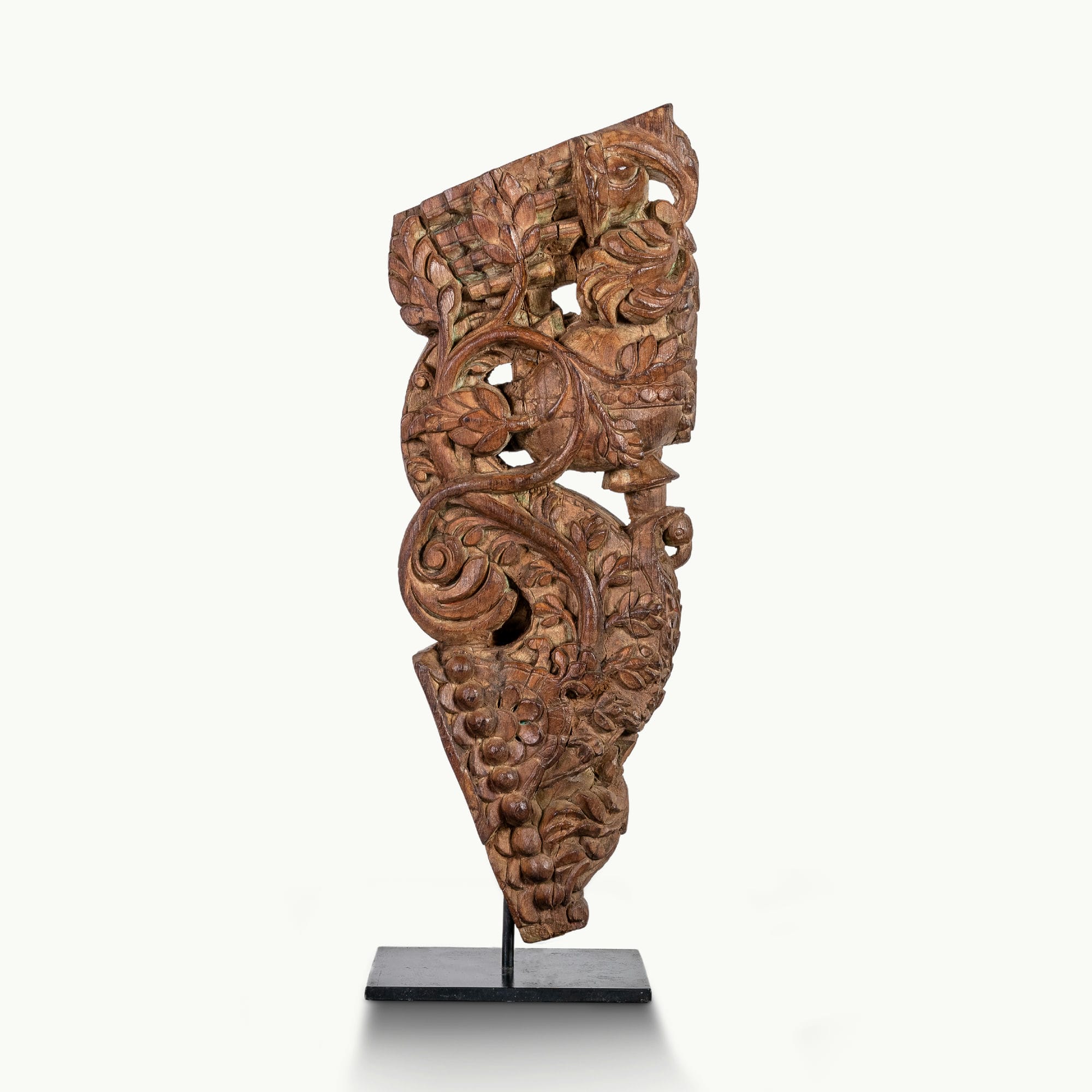 Carved wooden haveli bracket featuring a mythological avian sentinel.