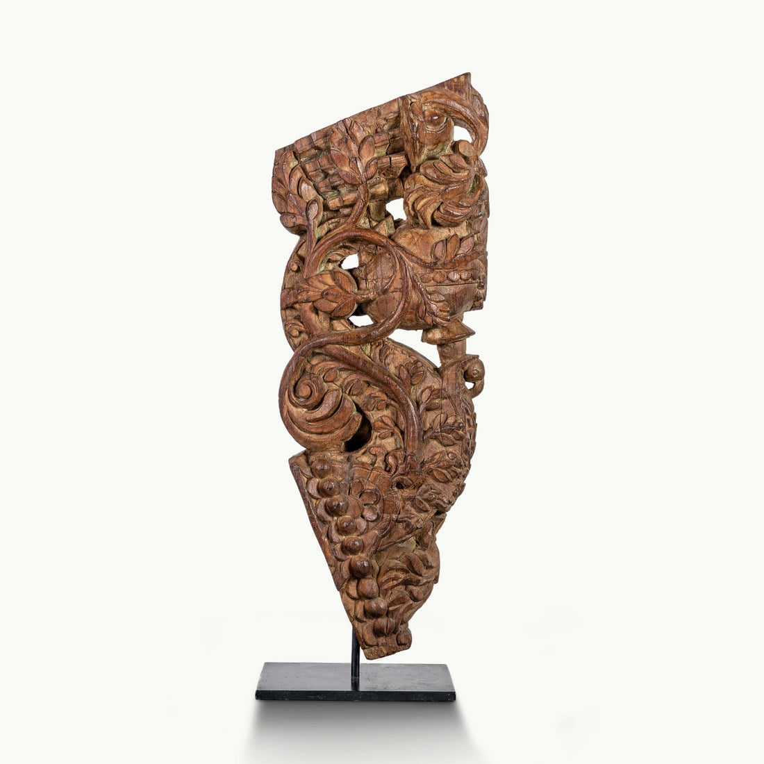 Carved wooden haveli bracket featuring a mythological avian sentinel.