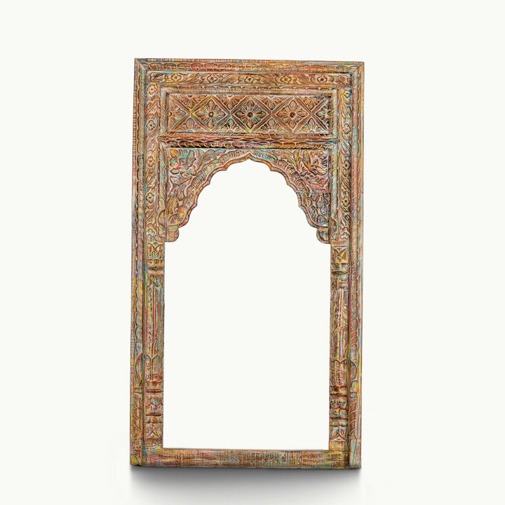 Polychrome carved wooden wall frame featuring a deeply carved cusped archway.