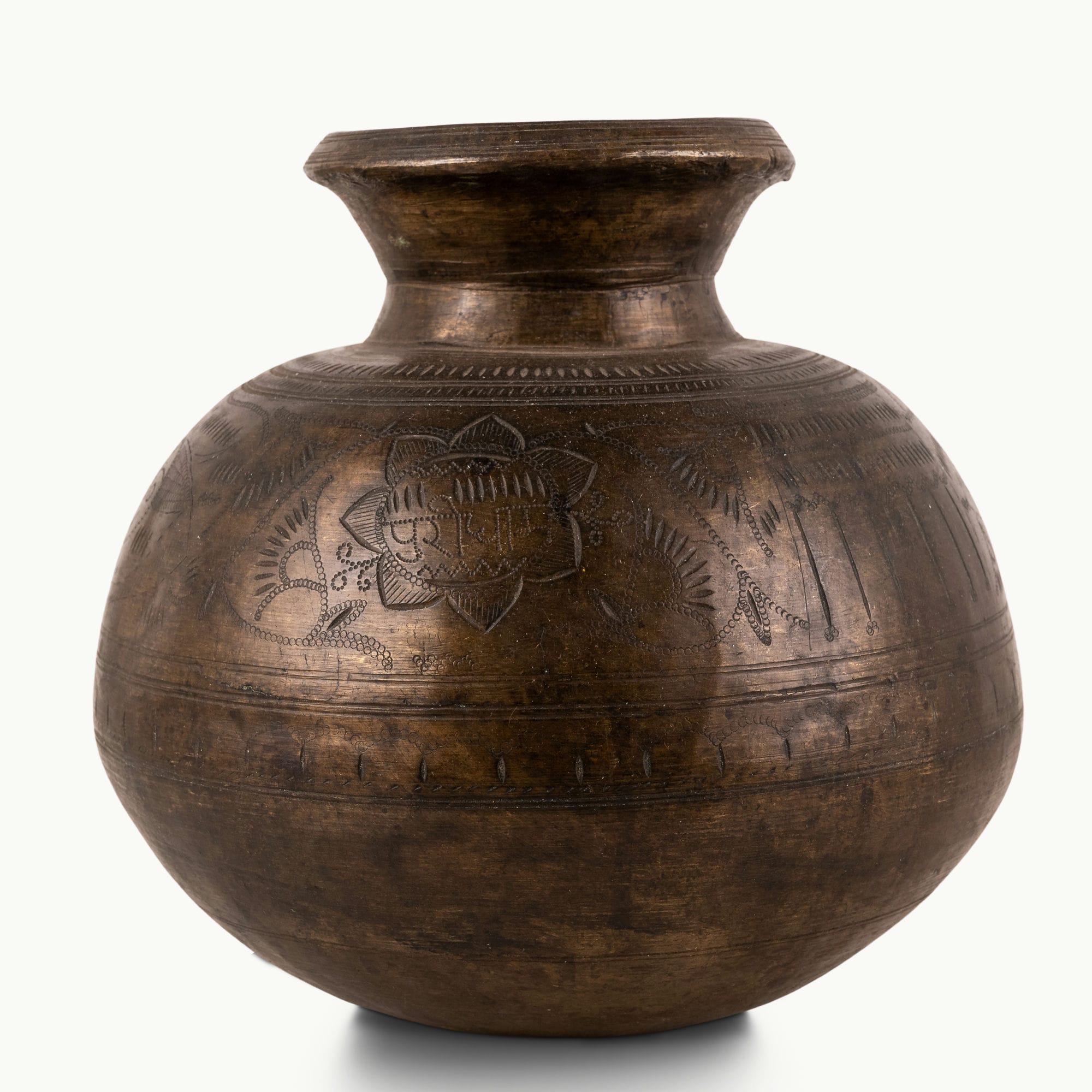 Engraved Antique Brass Water Pot chased for a rustic wooden console.