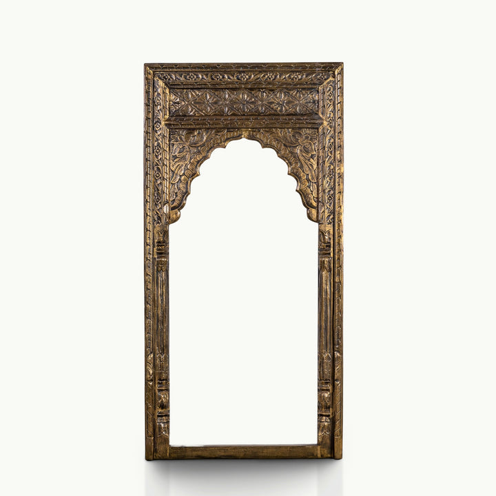 Monumental repousse brass archway panel featuring an Indian cusped opening and floral borders.