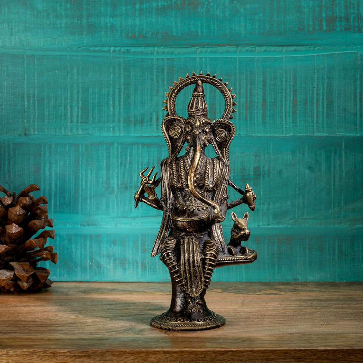 Four-armed Ganpati decor accompanied by Mooshak the mouse on a pedestal for an illuminated living room alcove or festive Diwali decor.