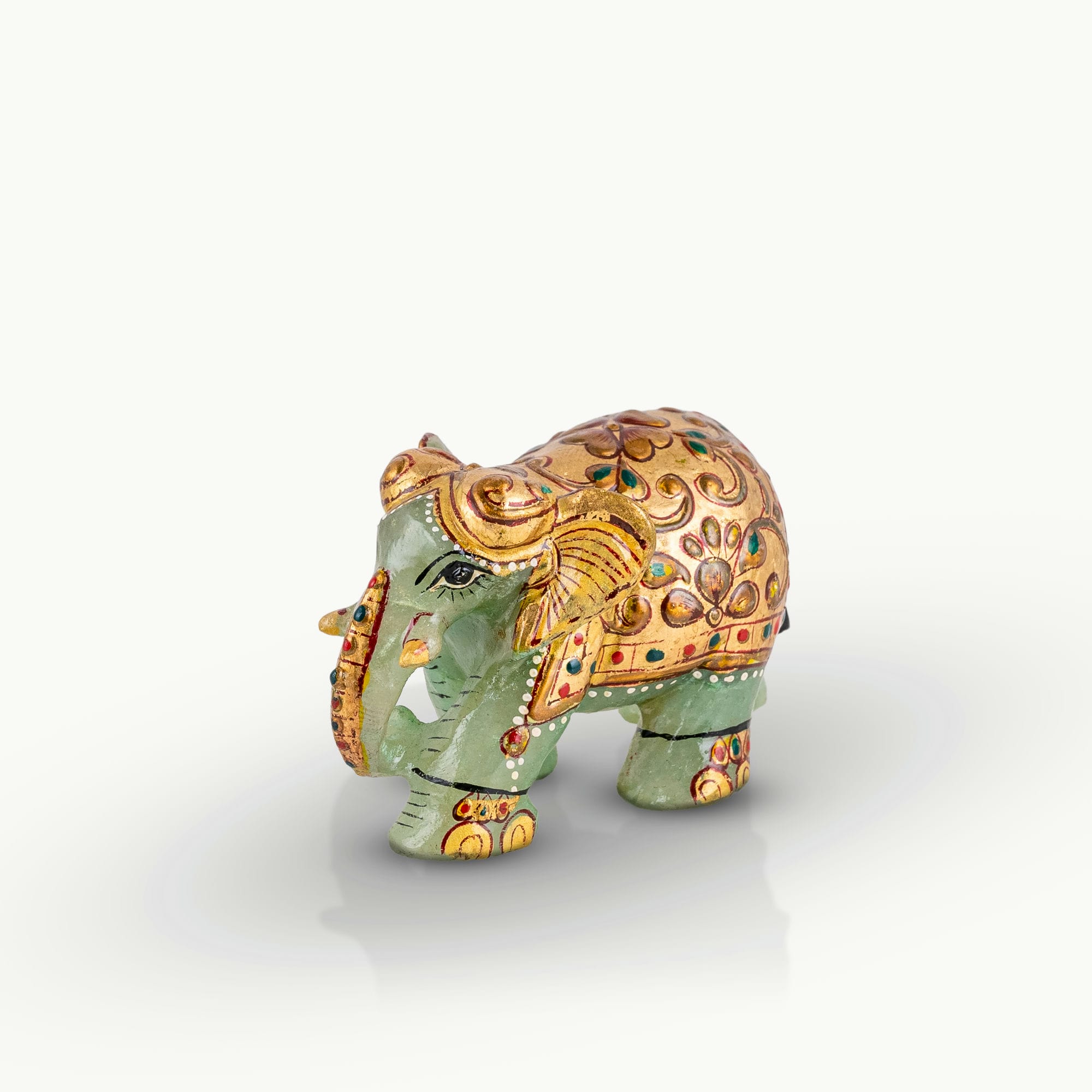 Hand-painted green marble elephant with gold ceremonial details.