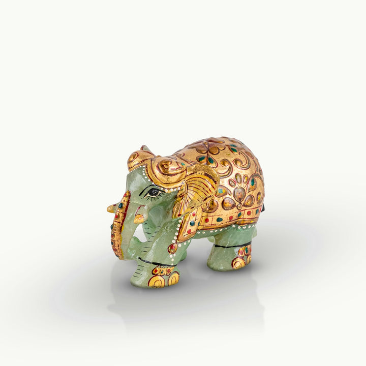 Hand-painted green marble elephant with gold ceremonial details.