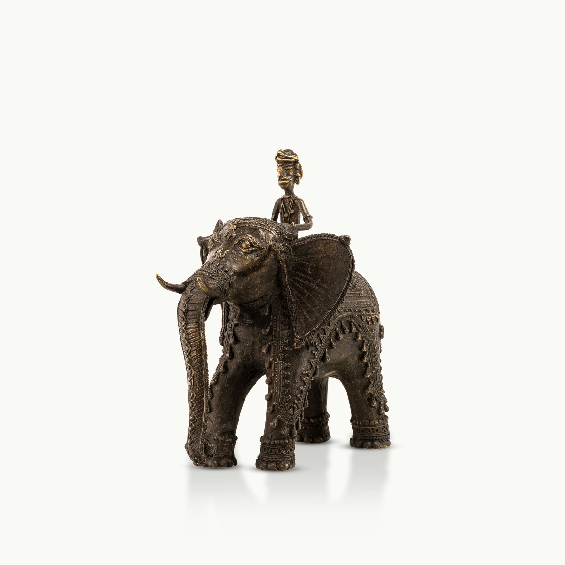 Dhokra Brass Elephant Rider Statue capturing ceremonial progress on a rustic wooden console. 