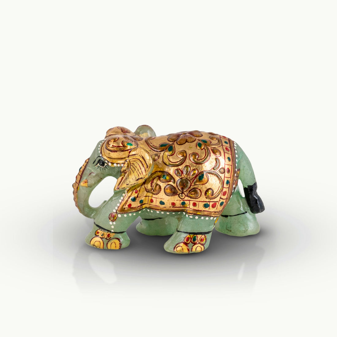 Hand-painted green marble elephant with gold ceremonial details.