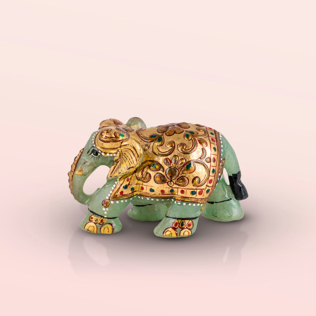 Hand-painted green marble elephant with gold ceremonial details.