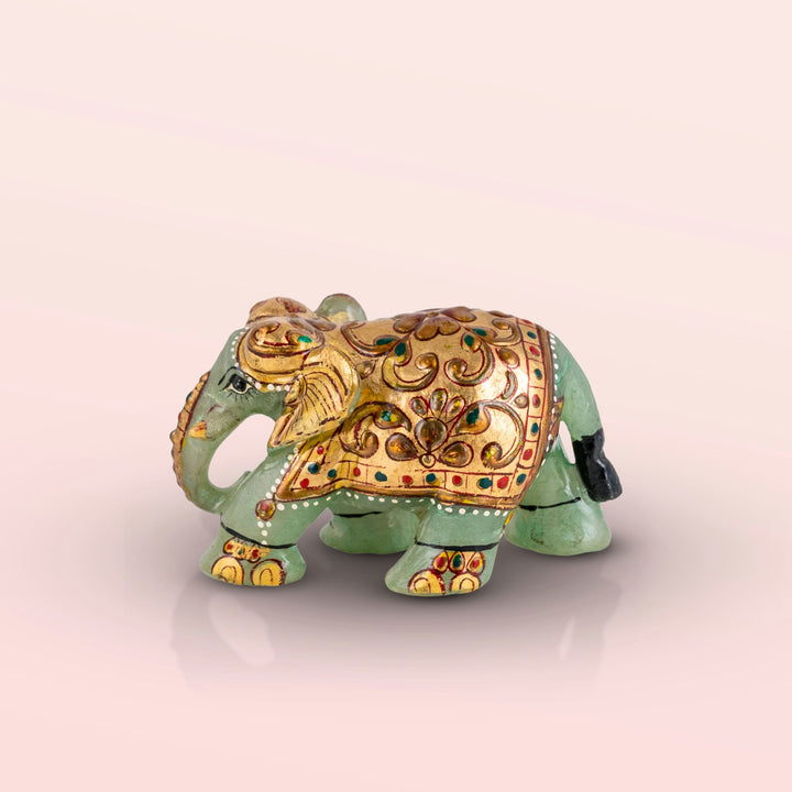 Hand-painted green marble elephant with gold ceremonial details.