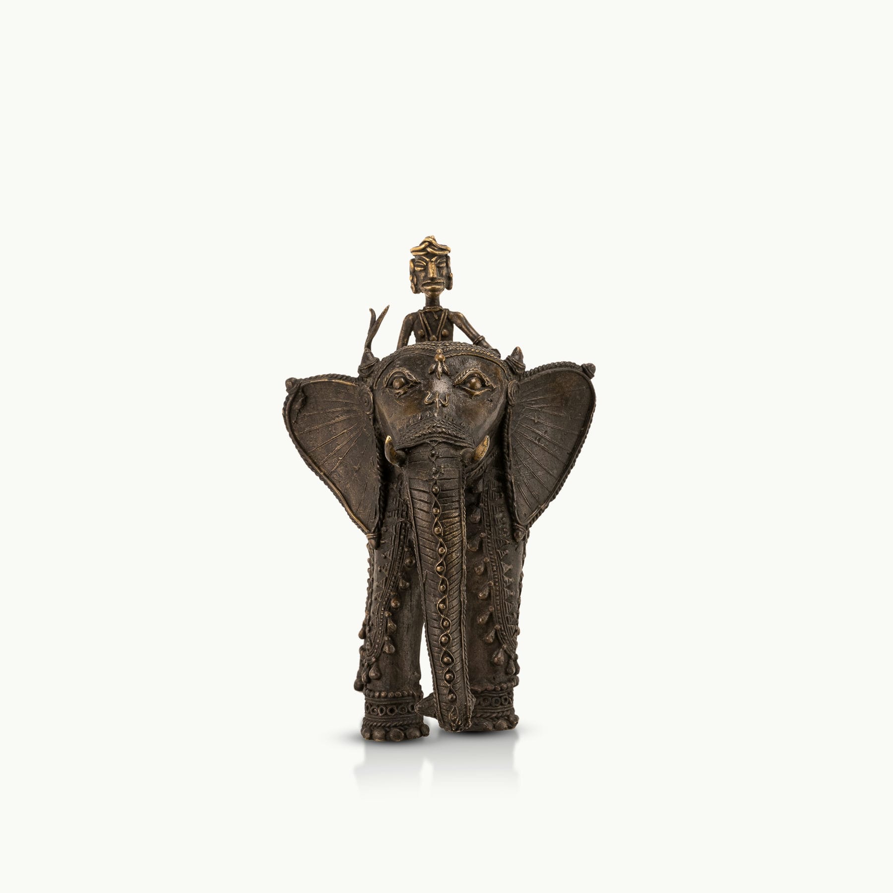 Dhokra Brass Elephant Rider Statue capturing ceremonial progress on a rustic wooden console. 