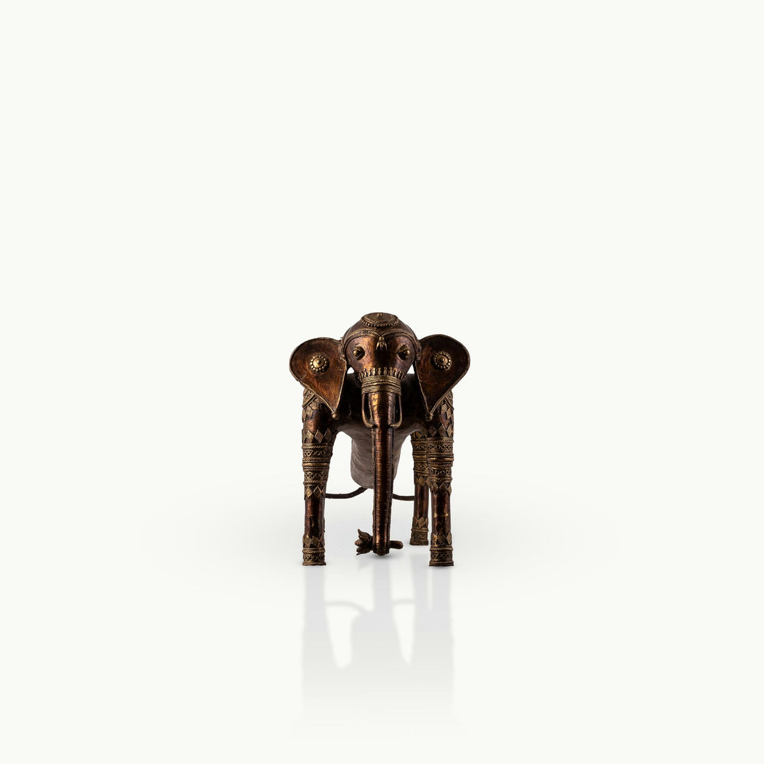 Elongated Dhokra Elephant Sculpture with a dipping back for a minimalist console.