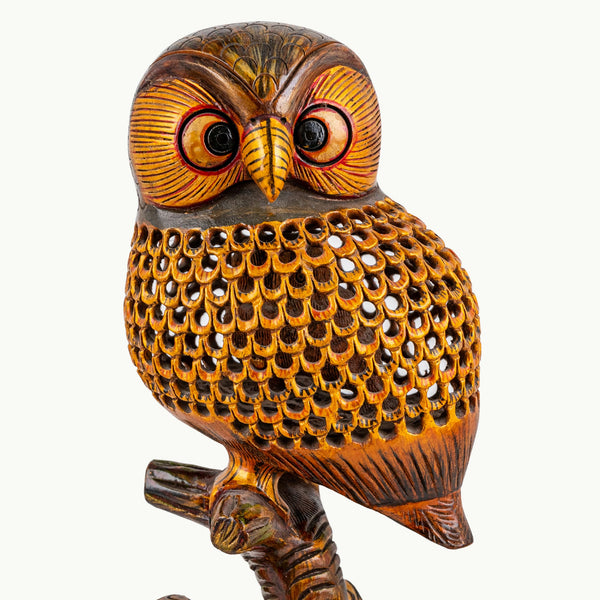 Pierced rosewood owl sculpture with three miniature owlets and an intricate honeycomb wooden lattice.