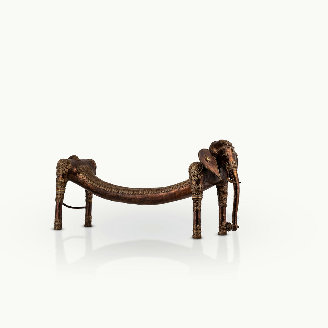 Elongated Dhokra Elephant Sculpture with a dipping back for a minimalist console.
