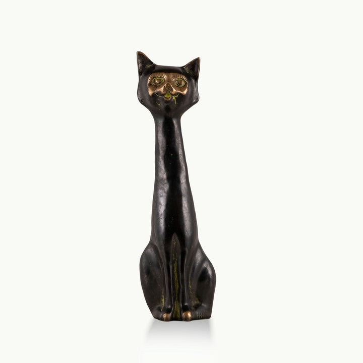 Elongated Black Brass Cat Sculpture in upright observation on an open display shelf. 