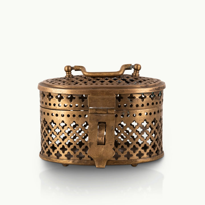 Antique Brass Pierced Oval Box featuring a delicate quatrefoil lattice for a walnut dresser.