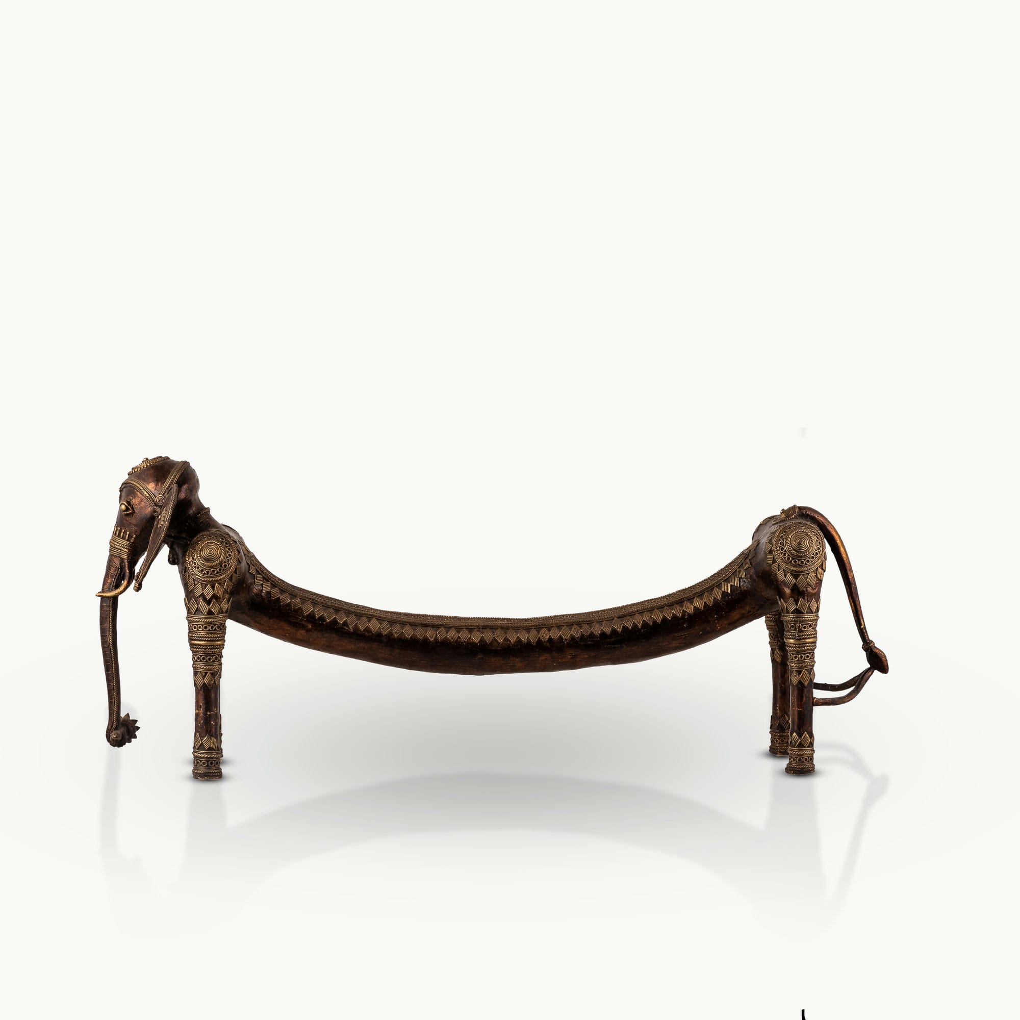 Elongated Dhokra Elephant Sculpture with a dipping back for a minimalist console.