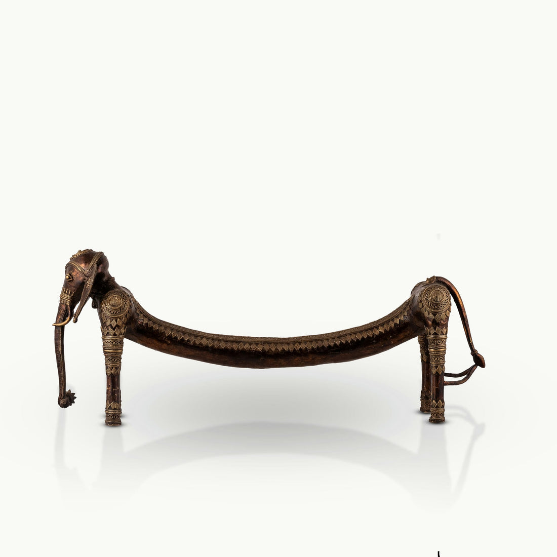 Elongated Dhokra Elephant Sculpture with a dipping back for a minimalist console.