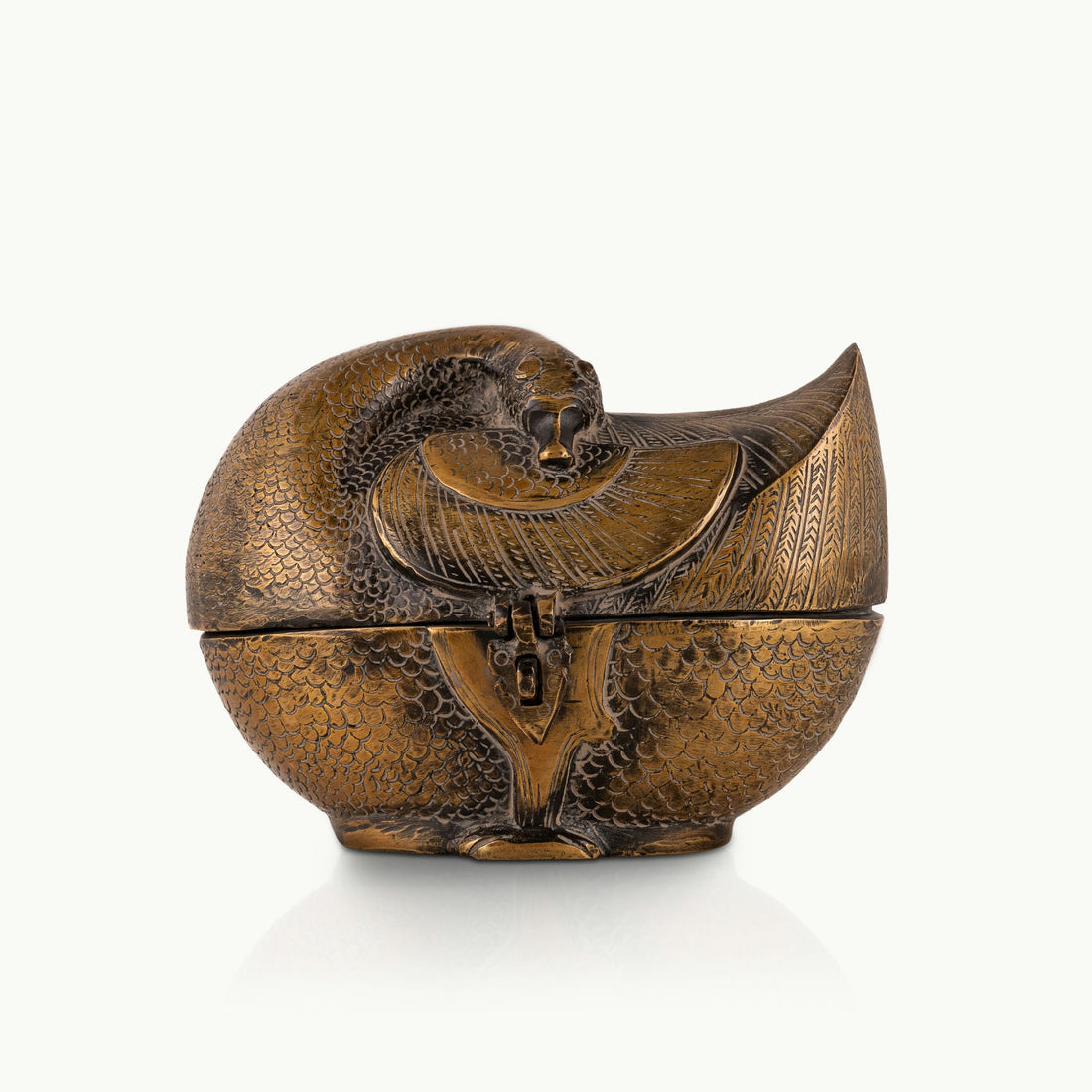 Antiqued Brass Bird Box featuring chased plumage details on a bedroom vanity. 