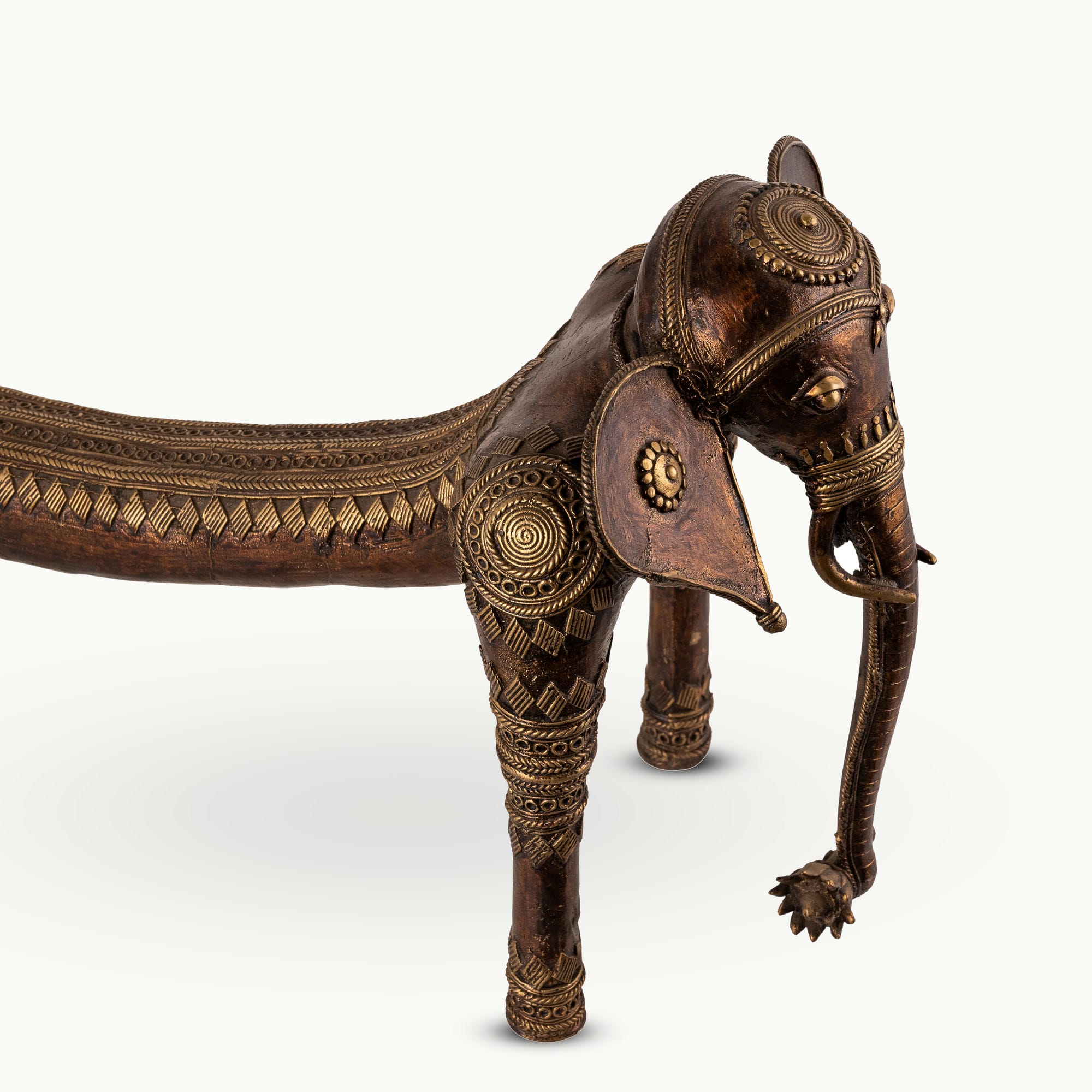Elongated Dhokra Elephant Sculpture with a dipping back for a minimalist console.