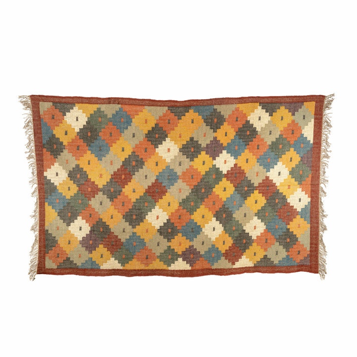Stepped diamond wool jute dhurrie in a living room, highlighting pixelated yellow and blue diamonds. 