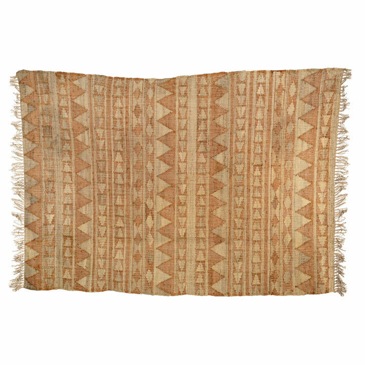 Flatweave cotton jute dhurrie in a living room, showcasing rhythmic terracotta triangles on sandy beige. 