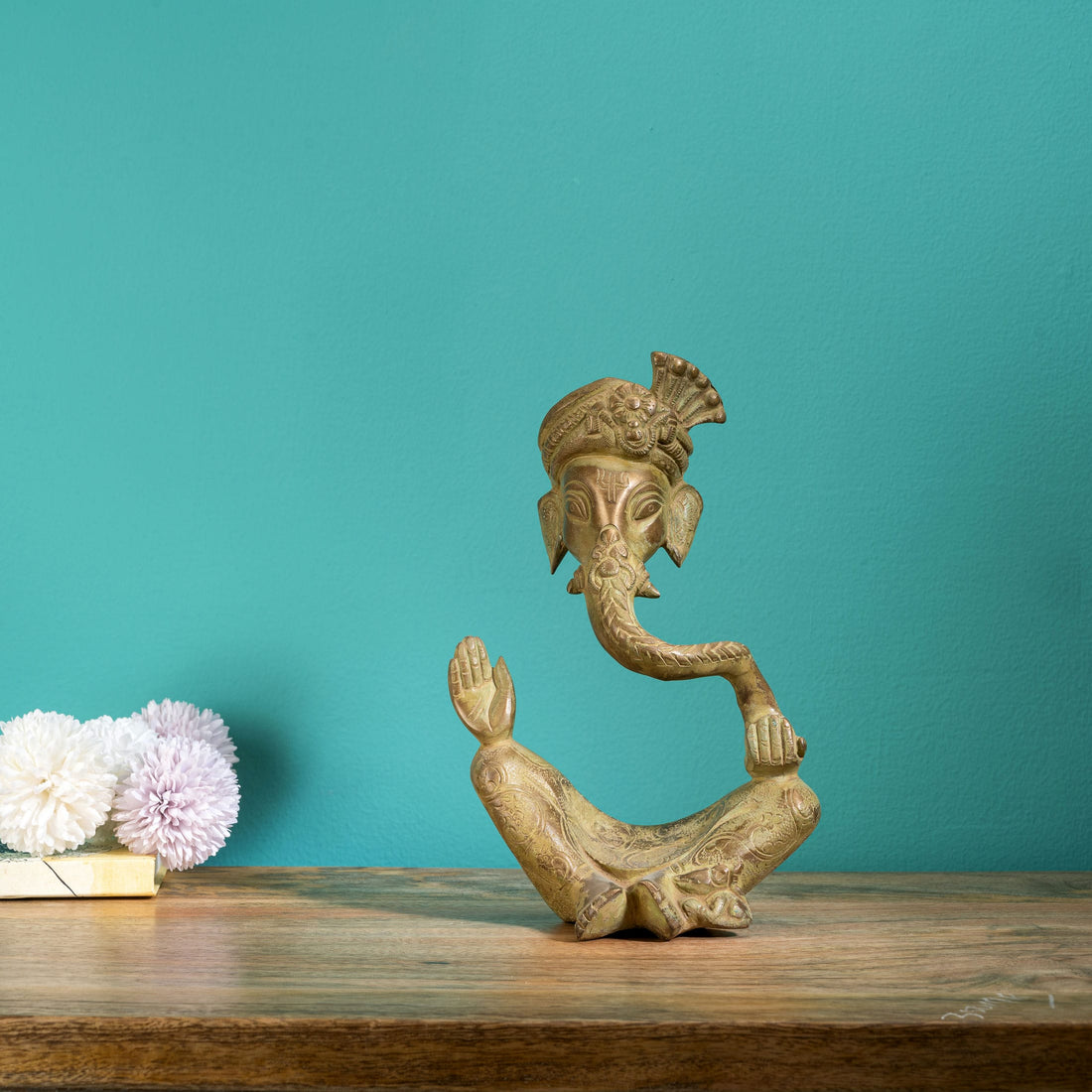 Antique abstract brass ganesha in meditative pose with turban
