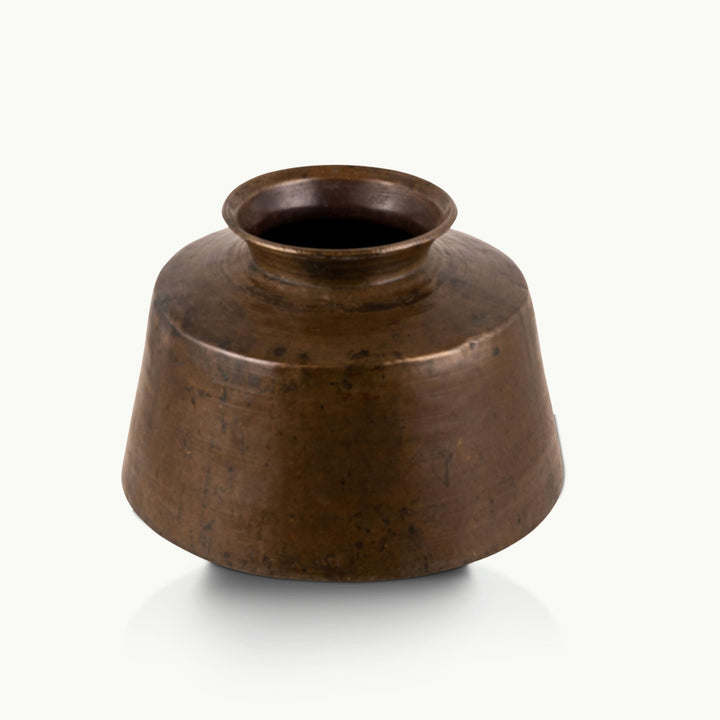 Large Antique Brass Handi with a wide conical shoulder for a light-wood entryway console.