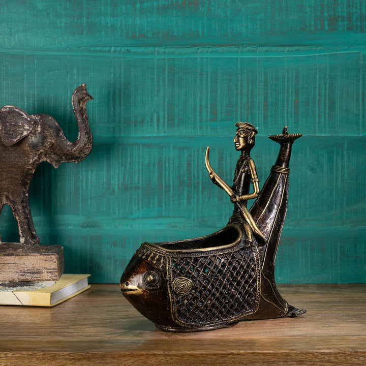 Tribal metal river vessel detailed with open-weave hull and a stylized boatman for a living room windowsill or traditional festive lighting.