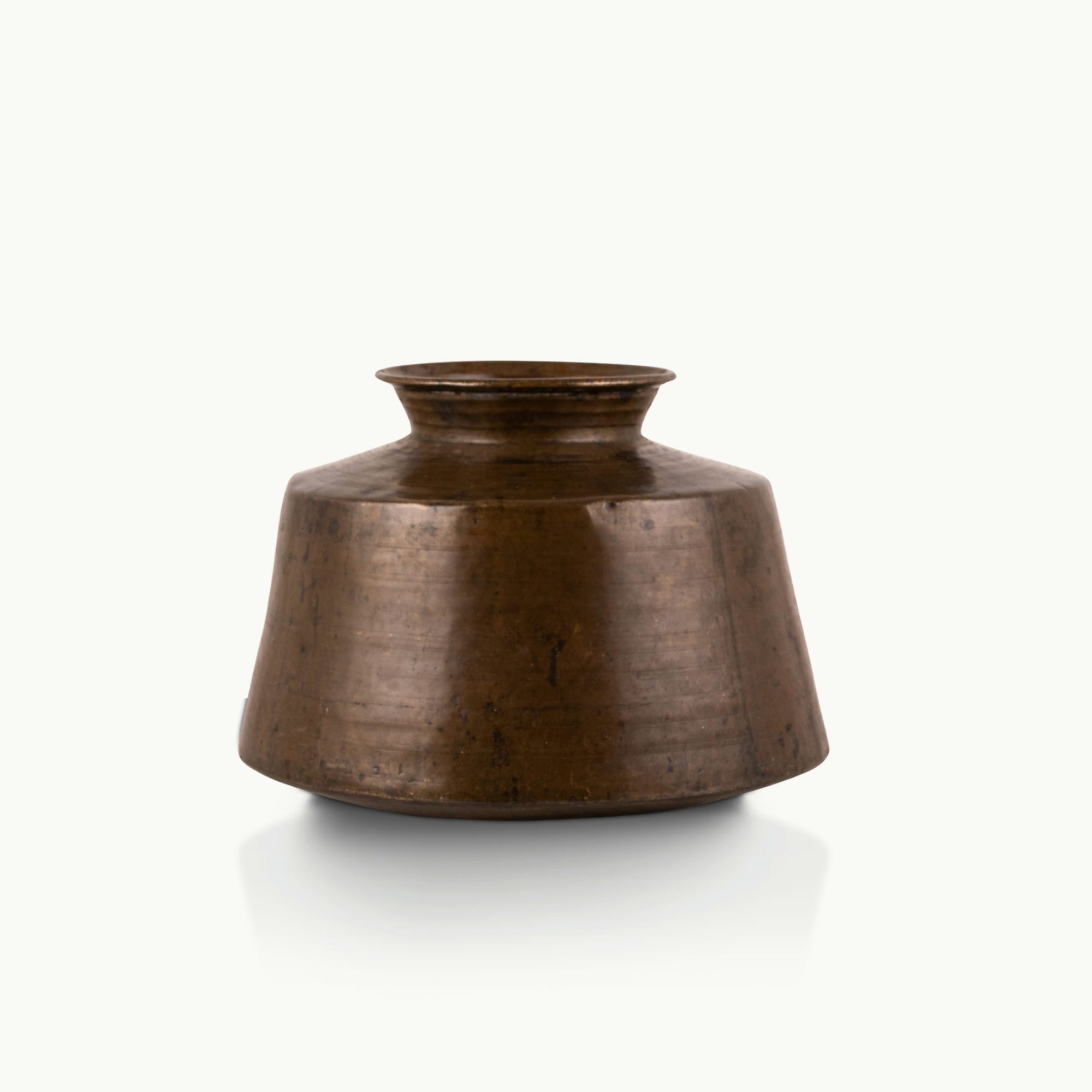 Large Antique Brass Handi with a wide conical shoulder for a light-wood entryway console.