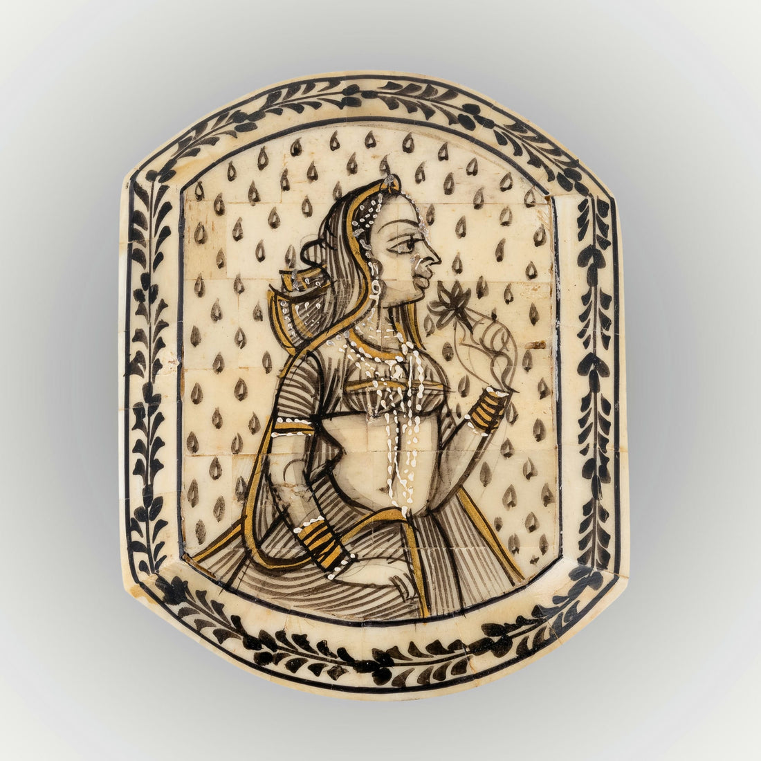 Portrait painted camel bone box featuring a Rajput noblewoman and black floral borders.