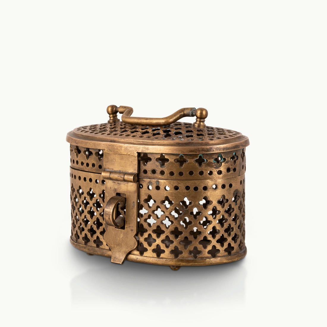 Antique Brass Pierced Oval Box featuring a delicate quatrefoil lattice for a walnut dresser.