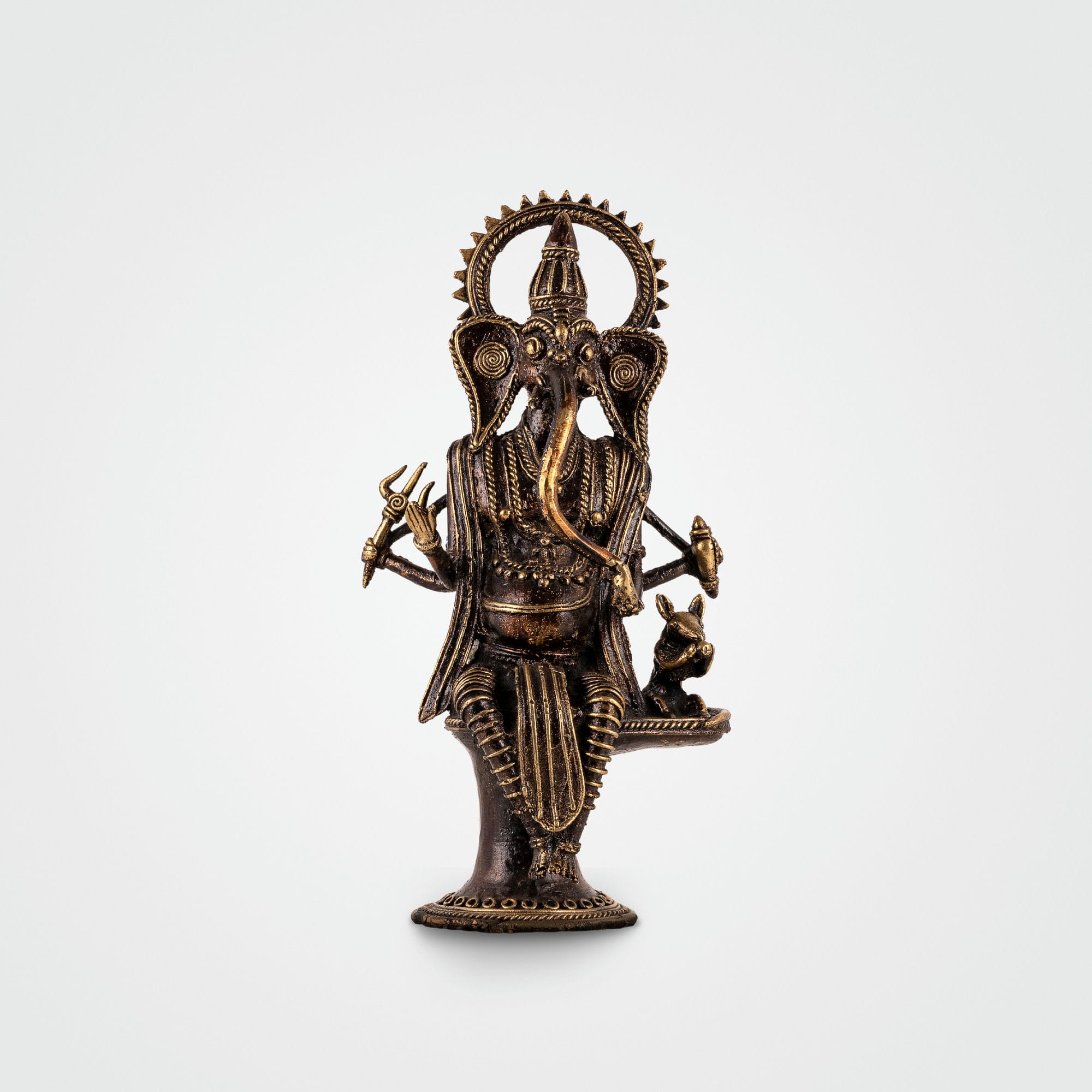 Brass Standing Ganesha Idol featuring a radiant halo in an illuminated living room alcove. 