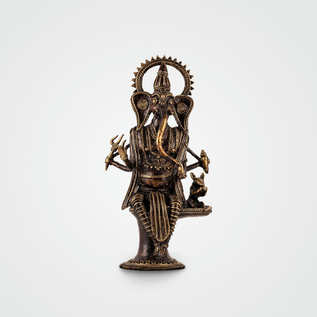 Brass Standing Ganesha Idol featuring a radiant halo in an illuminated living room alcove. 