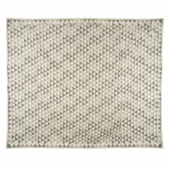 Geometric block-print cotton bedcover featuring a grey and taupe triangle lattice, styled in a modern master bedroom.