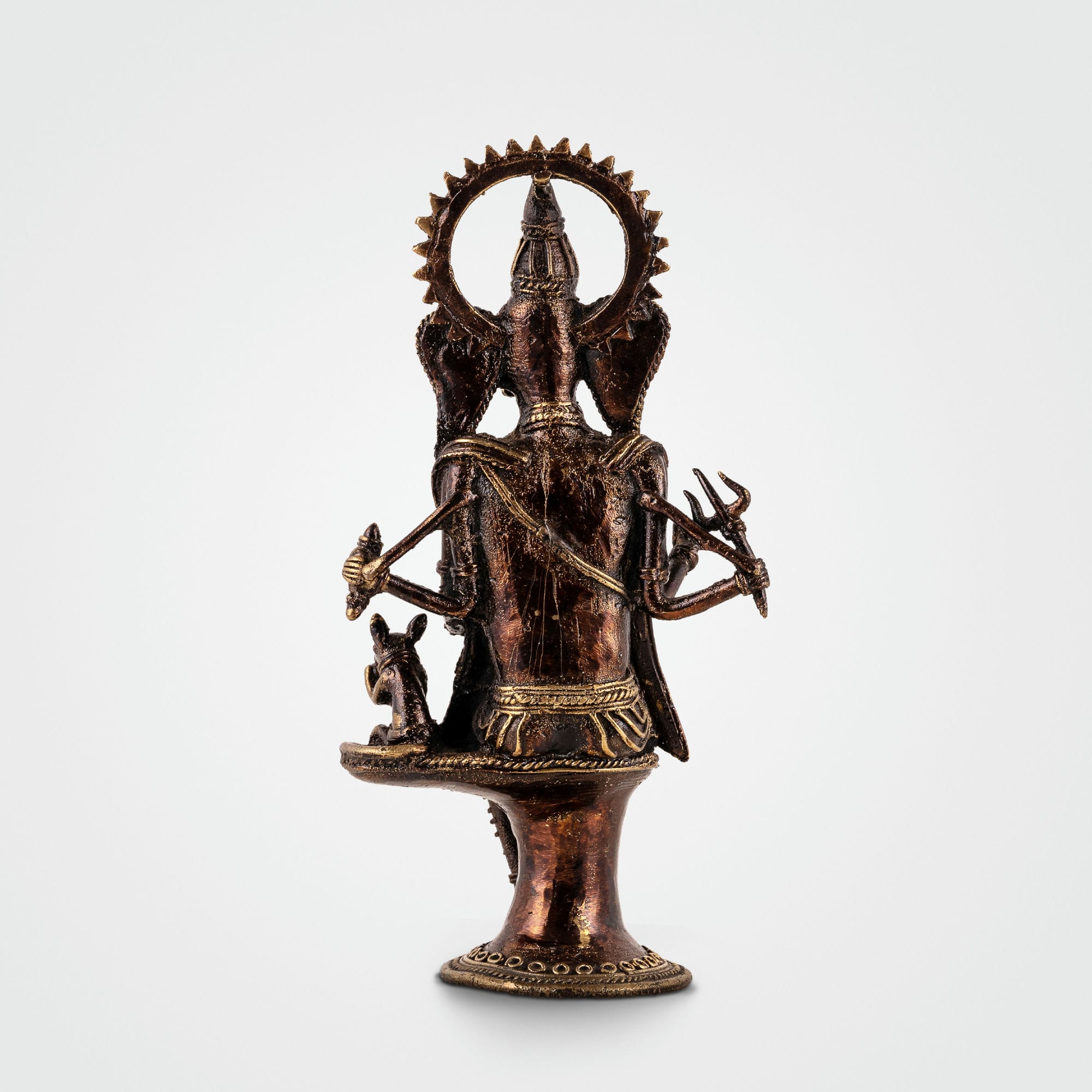Four-armed Ganpati decor accompanied by Mooshak the mouse on a pedestal for an illuminated living room alcove or festive Diwali decor.