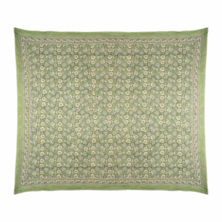 Floral block-print cotton bedcover featuring a sage green and powder blue lotus garden, styled in a sunlit master suite.