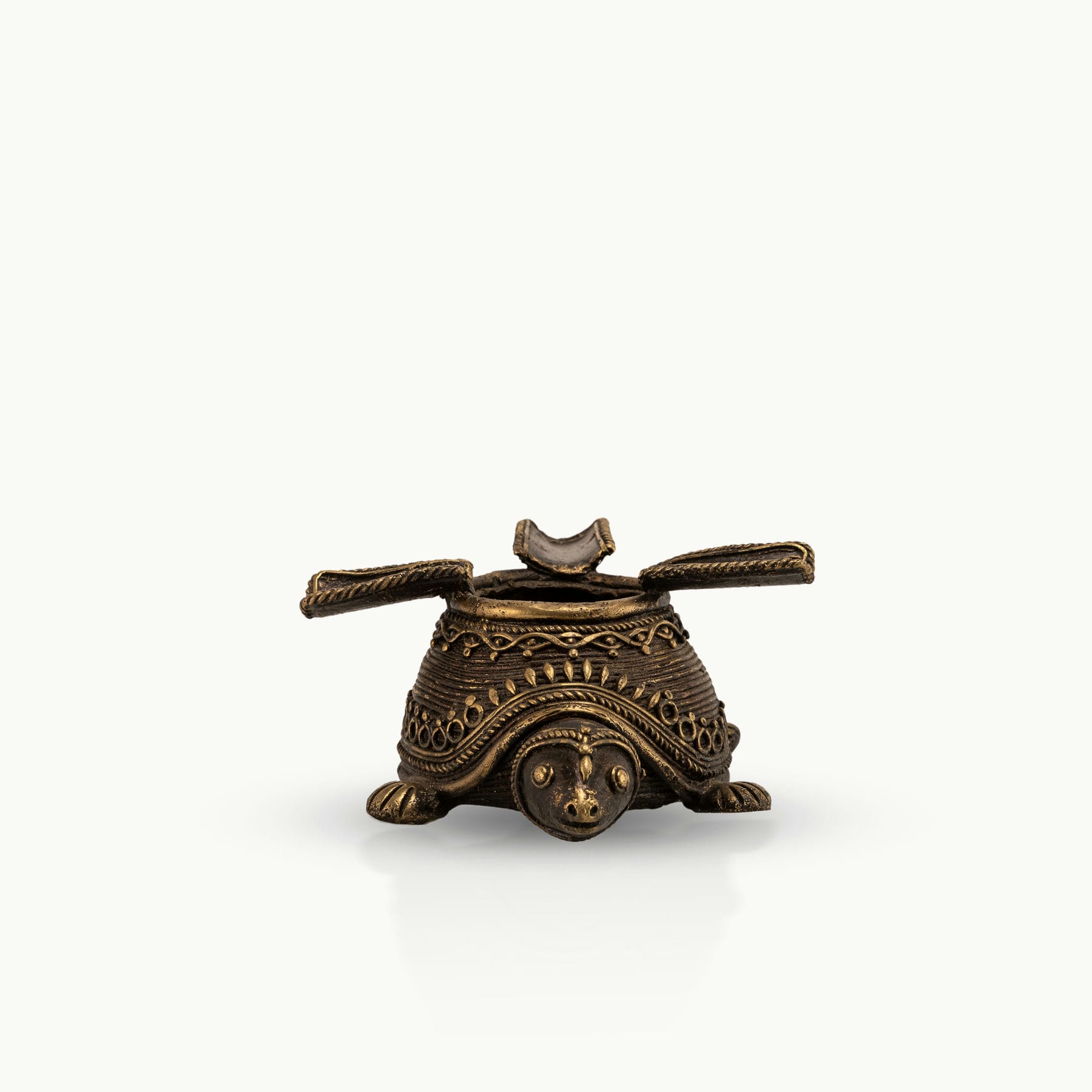 Dhokra Brass Turtle Ashtray featuring three hinged rests on a coffee table. 