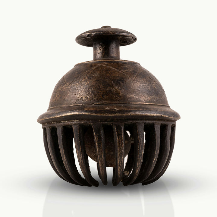 Antique Brass Elephant Bell enclosing a free-moving clapper for a walnut executive desk.