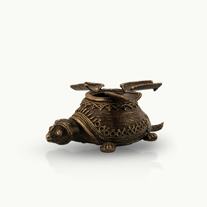 Dhokra Brass Turtle Ashtray featuring three hinged rests on a coffee table. 