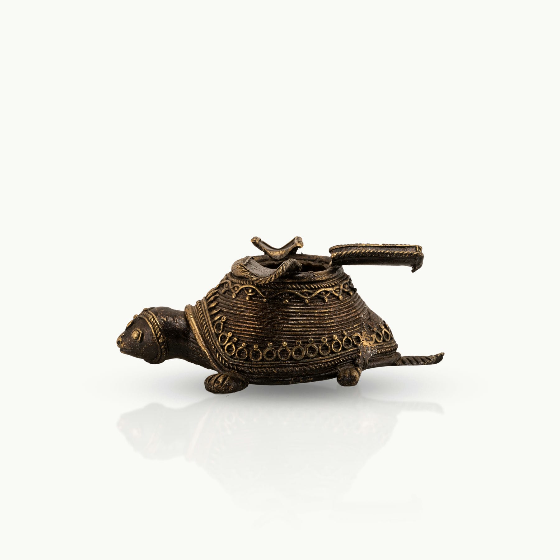 Dhokra Brass Turtle Ashtray featuring three hinged rests on a coffee table. 