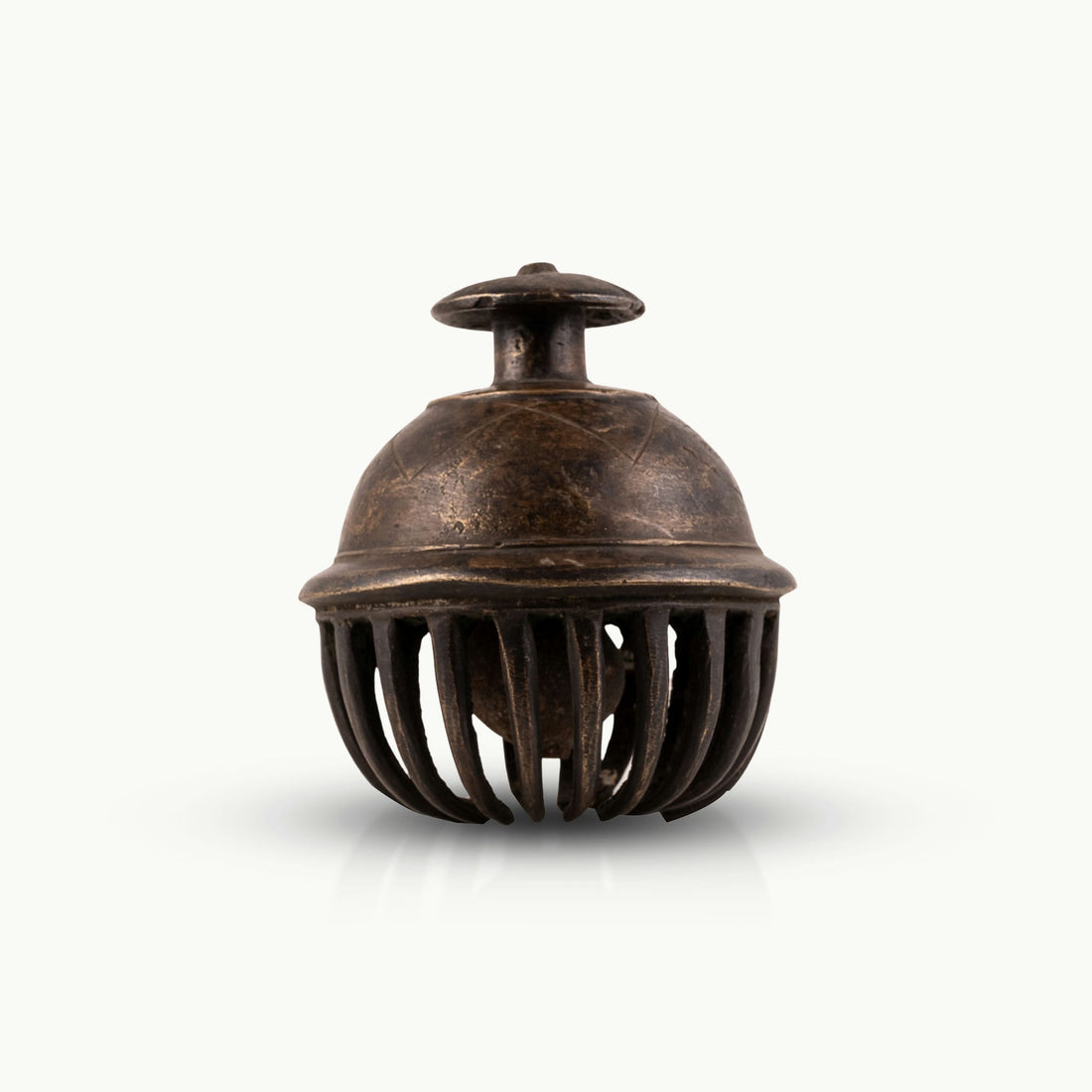 Antique Brass Elephant Bell enclosing a free-moving clapper for a walnut executive desk.