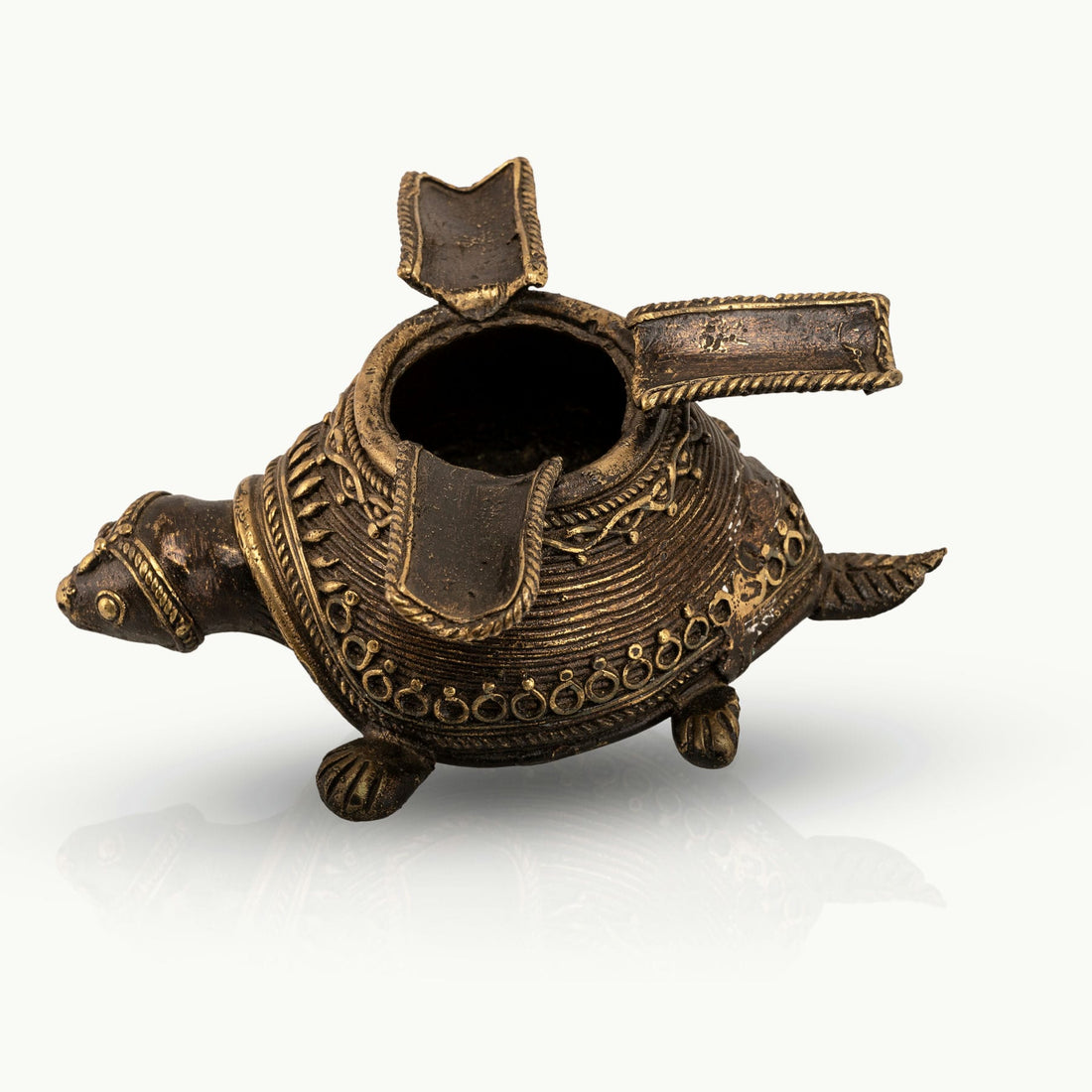 Dhokra Brass Turtle Ashtray featuring three hinged rests on a coffee table. 