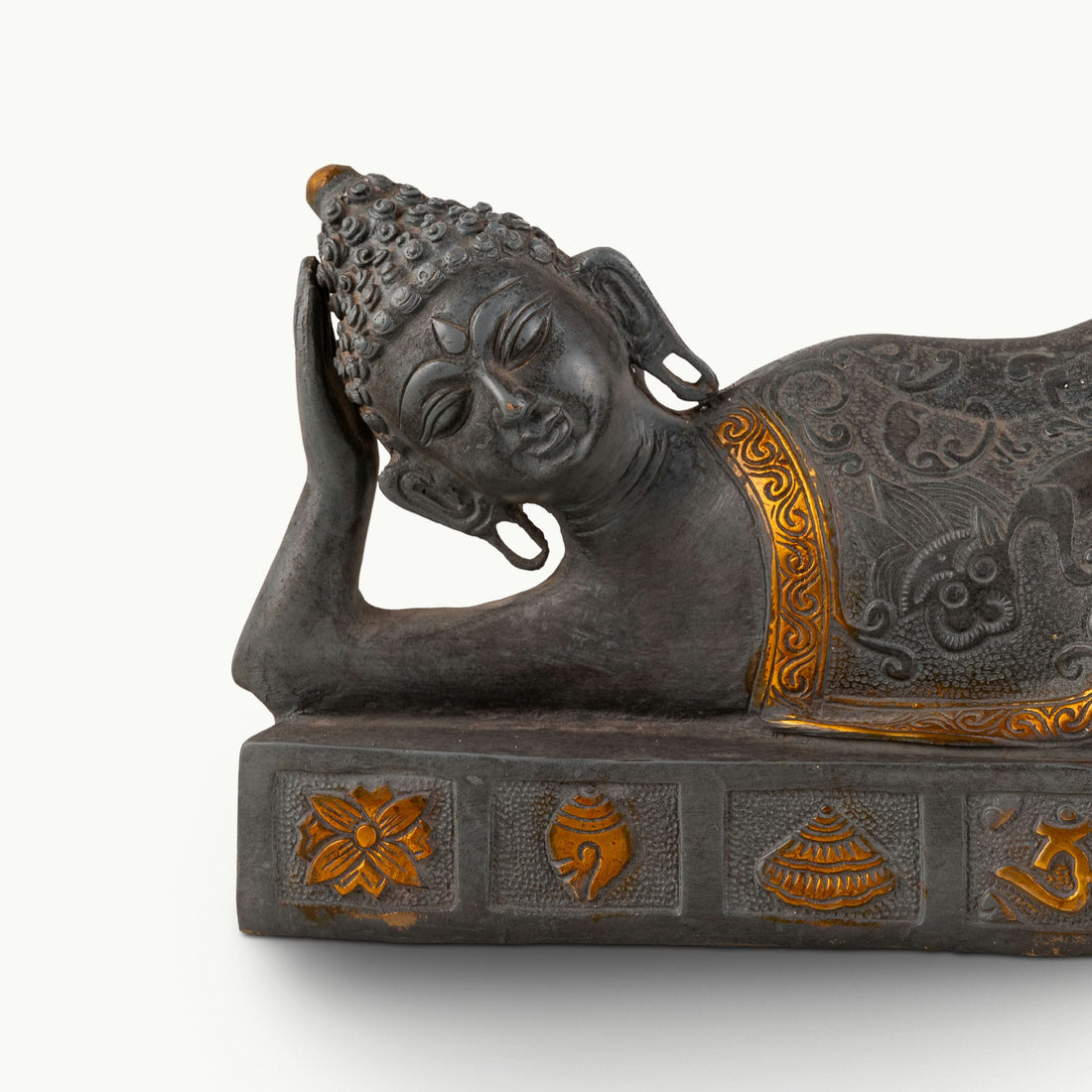 Dual-Tone Reclining Buddha Statue resting on a carved plinth for a meditation console.
