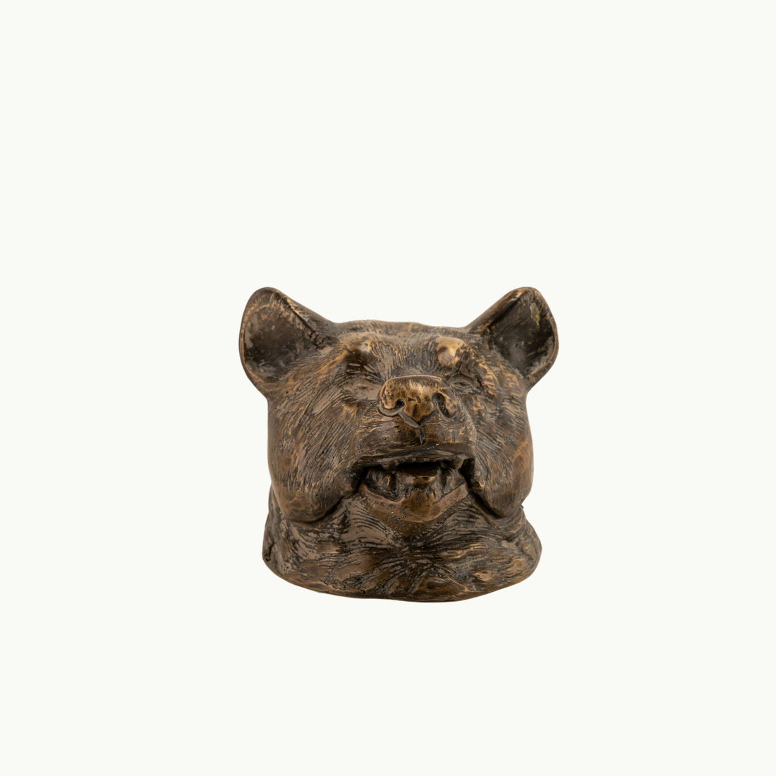 Antiqued Brass Bear Inkwell functioning as a rugged desk accessory on a study desk. 